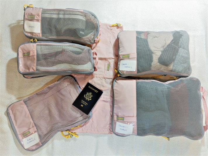 BAGSMART Compression Packing Cubes packed and spread out with a passport laying on top