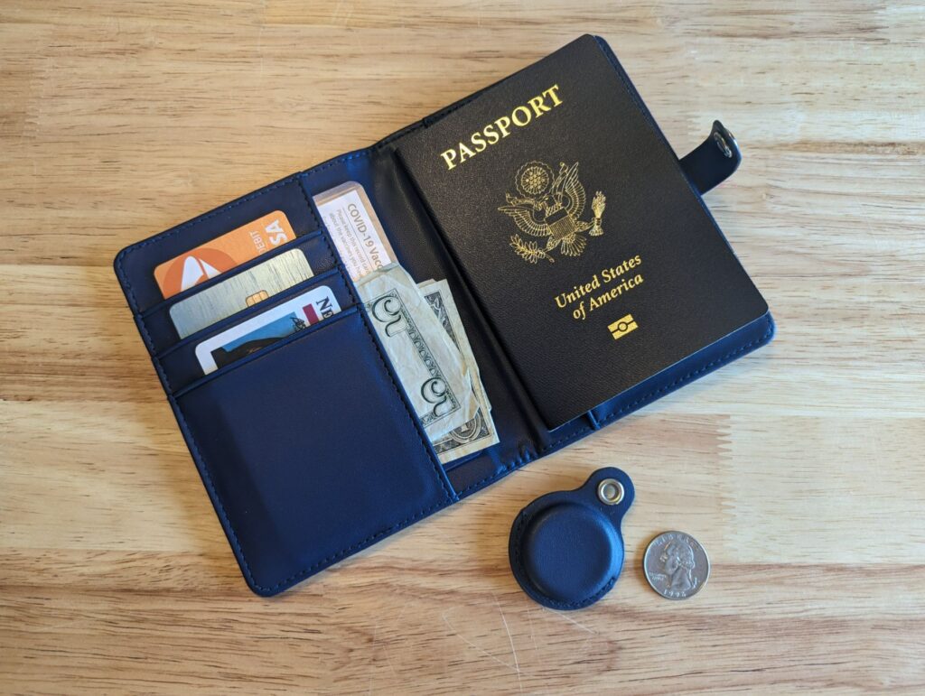 SIMPLY SOIRÉE AirTag Wallet open showing cash, passport, cards, and separate airtag holder